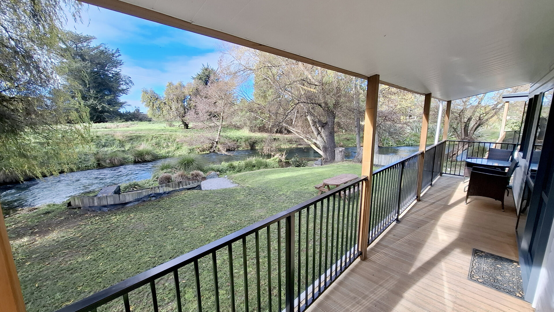 Two-bedroom cottage balcony 1 Two-bedroom cottage overlooking river at Blenheim Spring Creek Holiday Park